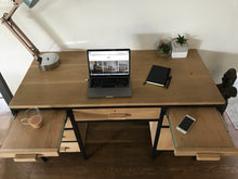 Load image into Gallery viewer, A Rebel Retro oak desk with black metal legs, featuring multiple drawers and a desk lamp.
