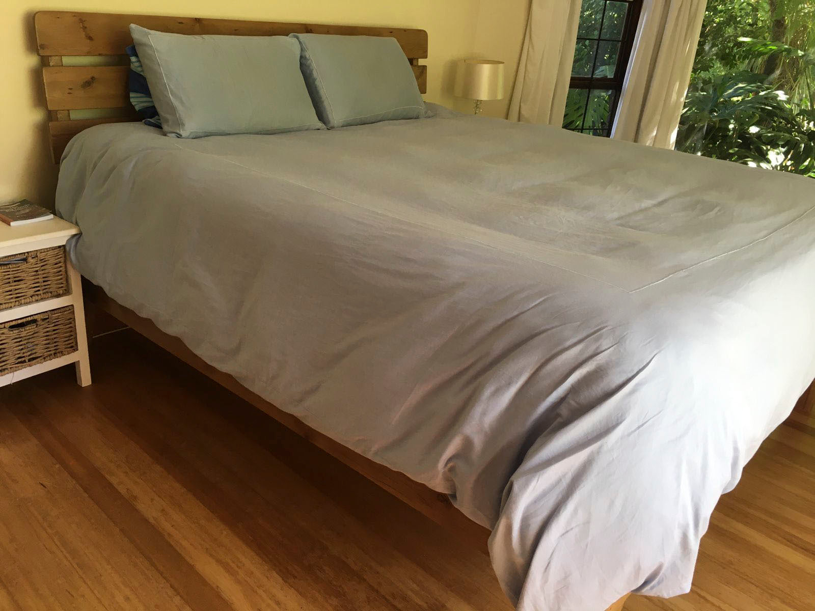 Hand crafted oak bed with slatted headboard.