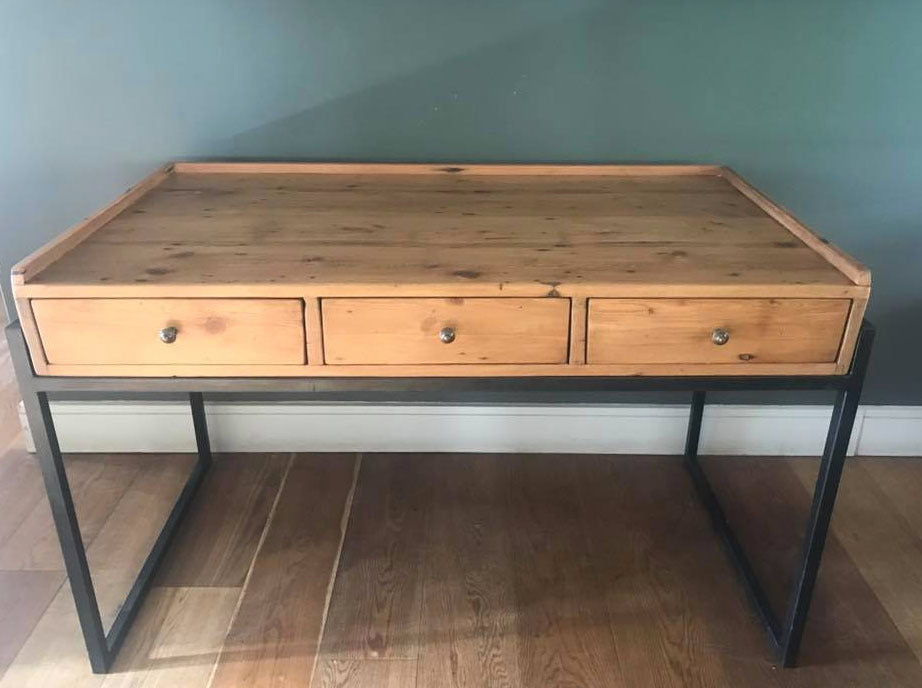 Hand crafted wooden desk with black metal legs.
