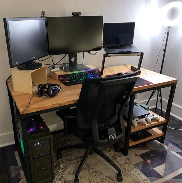 Custom reclaimed wood study desk with black metal legs and side shelves for storage. 