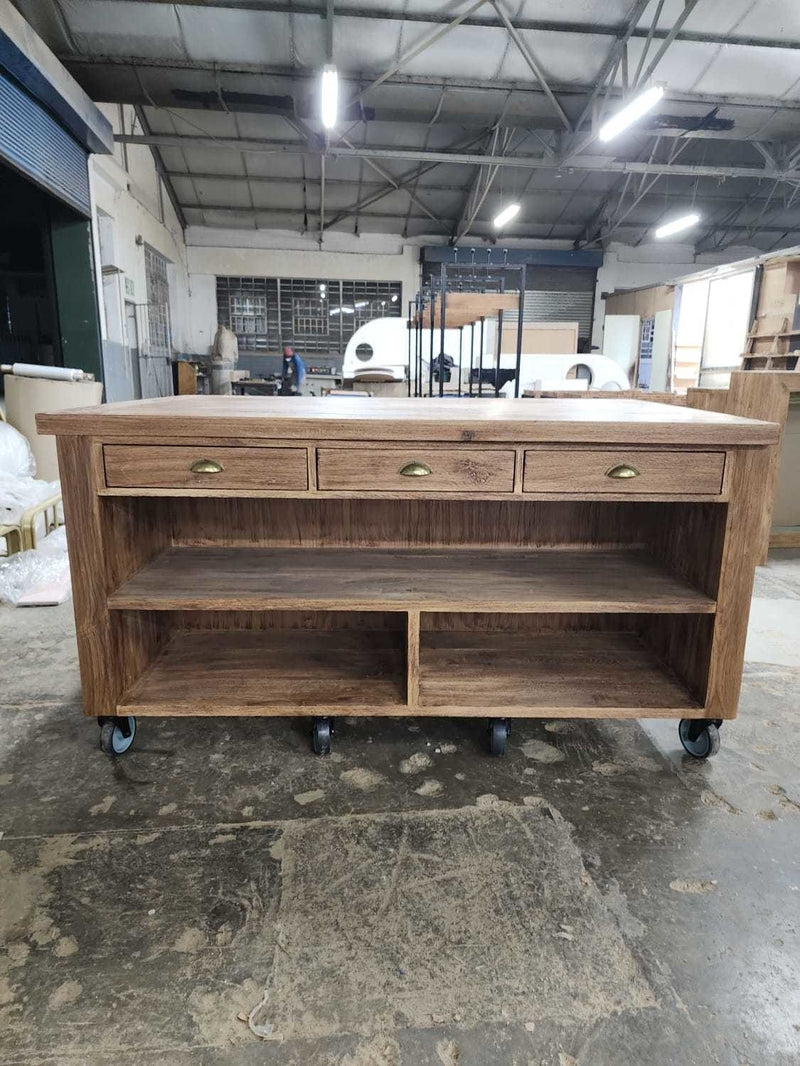 Large custom made wooden kitchen island on wheels with multiple draws and storage space. 