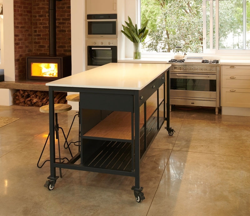 Modern kitchen with a large island flat counter top and black metal legs.