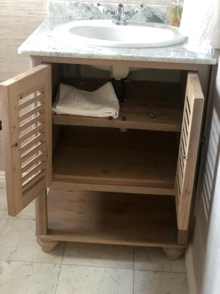 Custom made bathroom vanity with french style wooden doors.