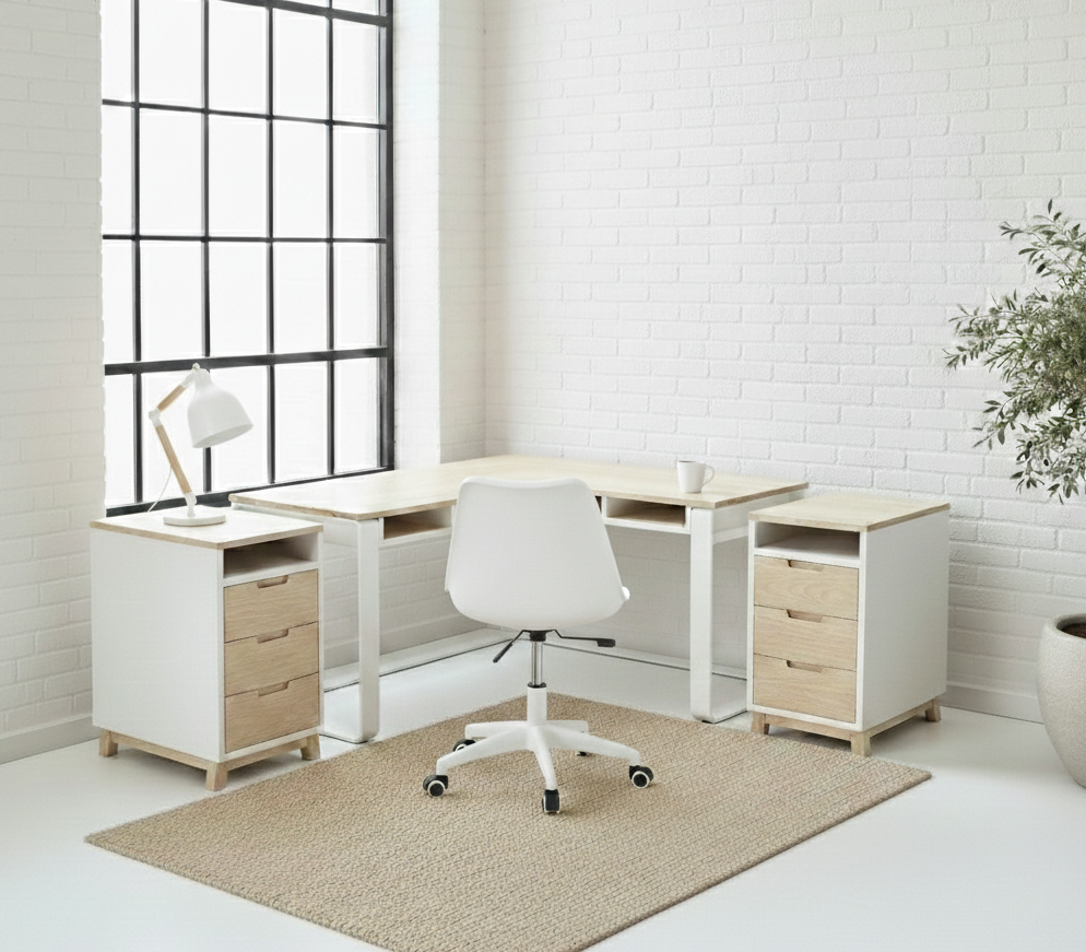 The Kiki L-Shape Desk features a solid Ash timber top on a matte black flat-bar steel frame with under-desk cubbies. Custom made to order in South Africa.