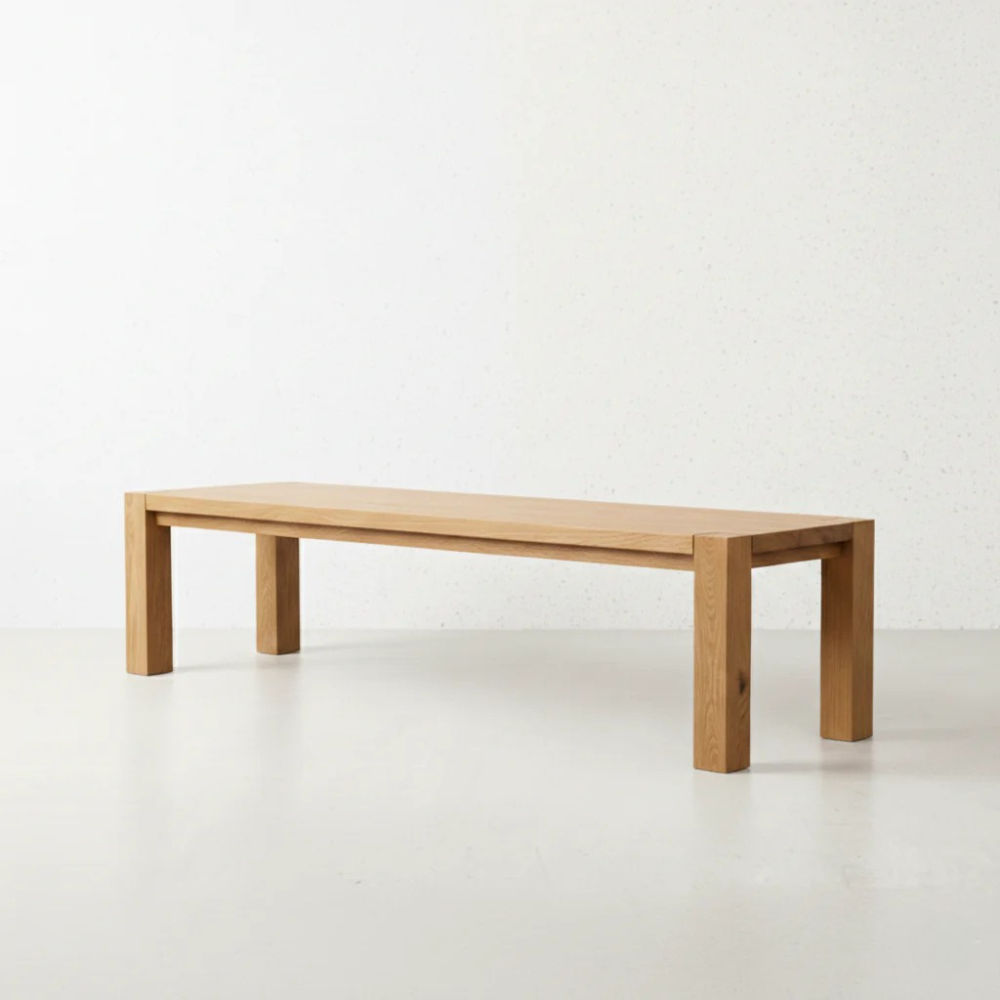 The Masai Oak Bench is handcrafted from solid oak with architectural cant-style legs. Pairs with the Masai Table or stands alone. Made to order in SA.