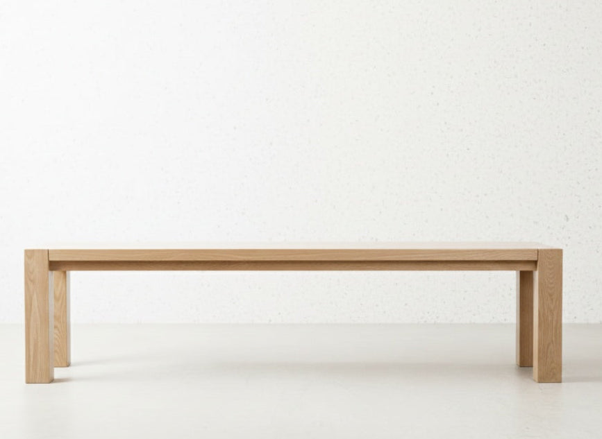 The Masai Oak Bench is handcrafted from solid oak with architectural cant-style legs. Pairs with the Masai Table or stands alone. Made to order in SA.
