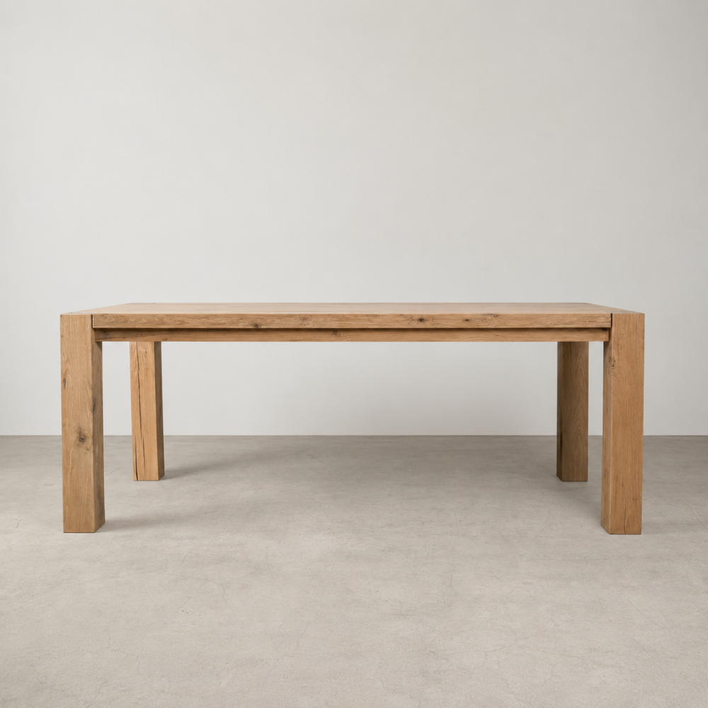 The Masai Oak Table is handcrafted from solid sustainably sourced oak with architectural cant-style legs and natural timber character. Made to order in SA.