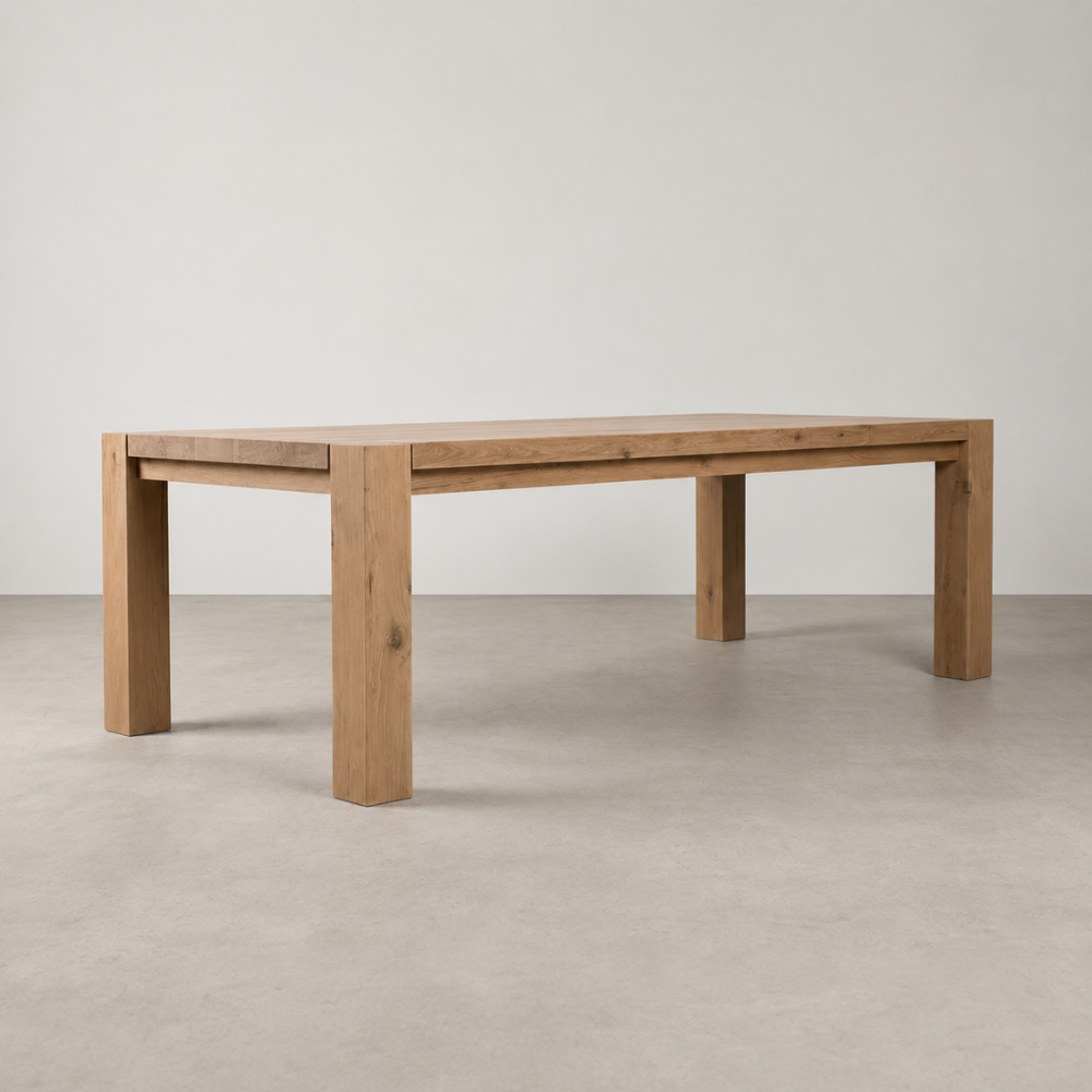 The Masai Oak Table is handcrafted from solid sustainably sourced oak with architectural cant-style legs and natural timber character. Made to order in SA.