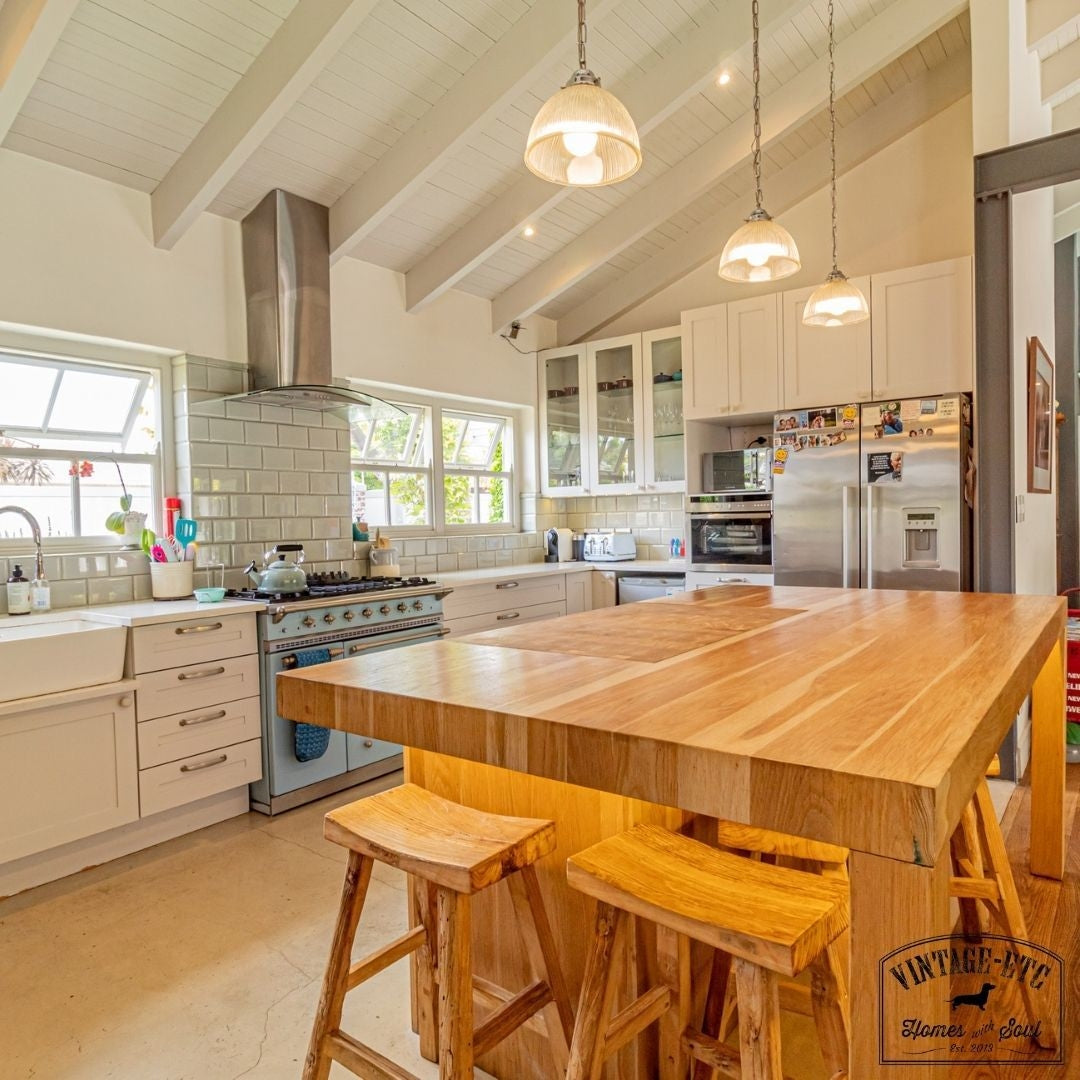 Custom made oak kitchen island unit with high stools.