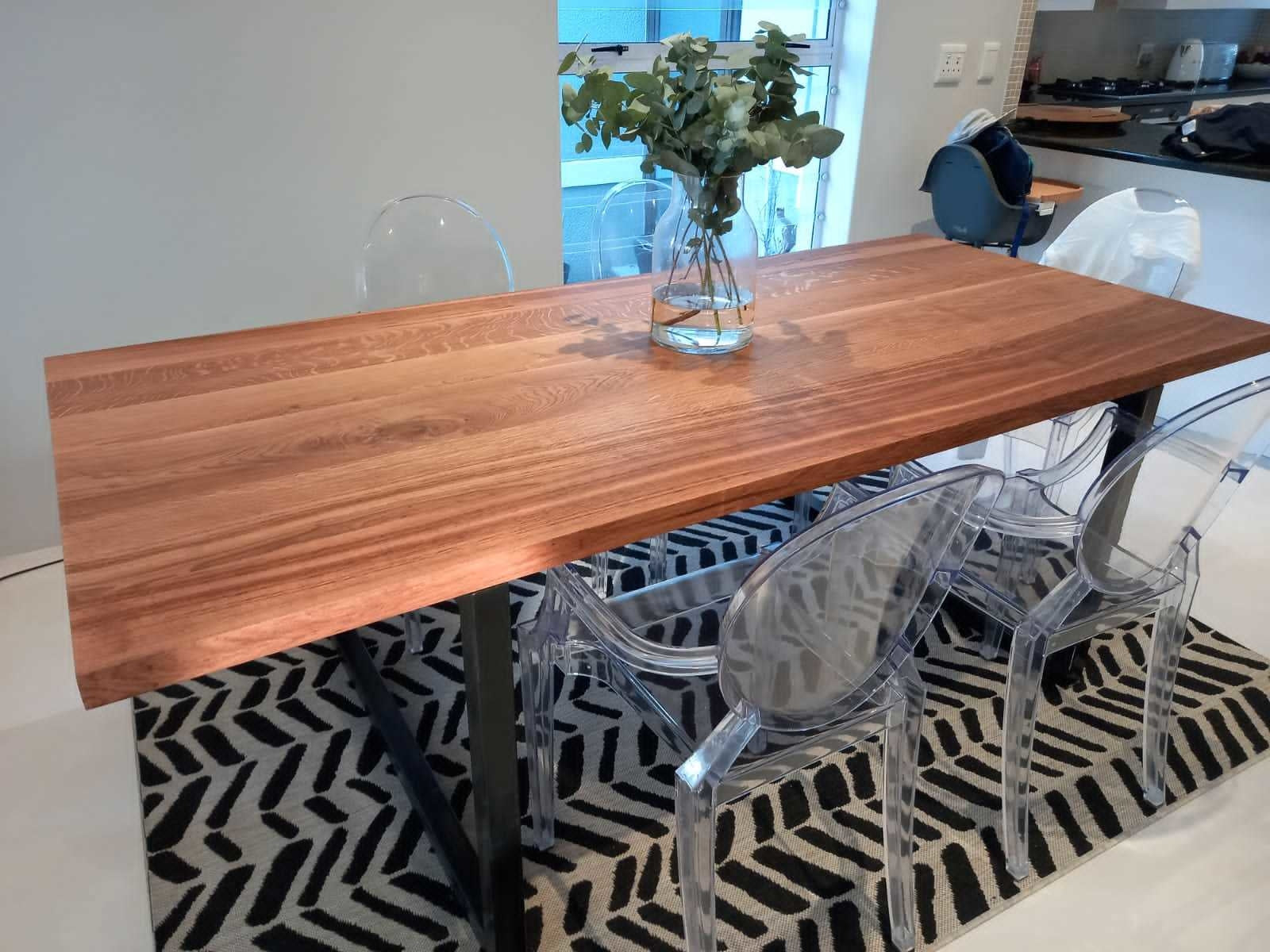 Custom made oak dining room table with black metal legs.