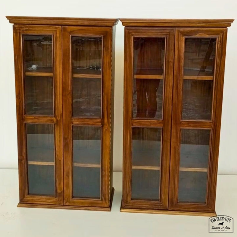 Two custom made wooden display cabinets with glass doors.