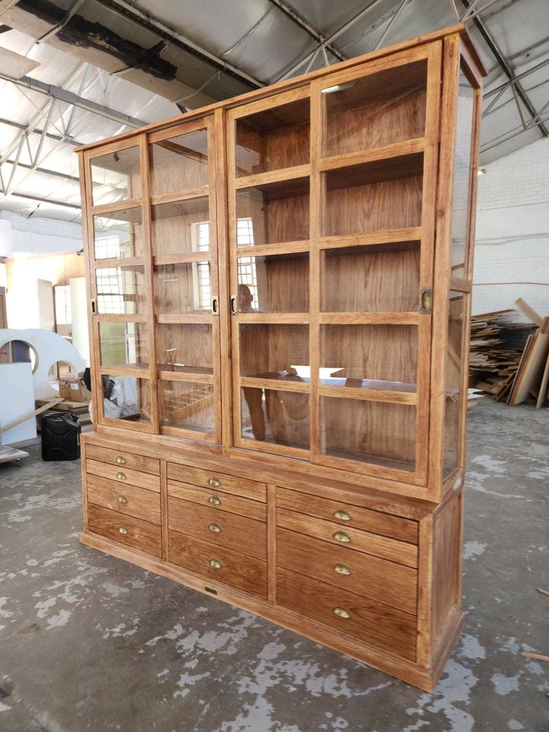 Large Custom Made Wooden Cabinet with sliding wooden doors and multi-draw compartment space.