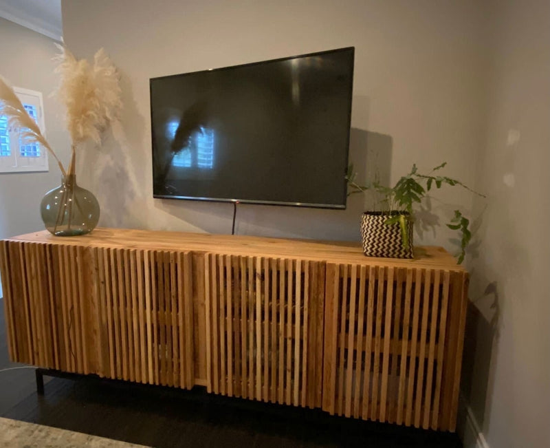 Custom made wooden tv unit on black metal legs. 