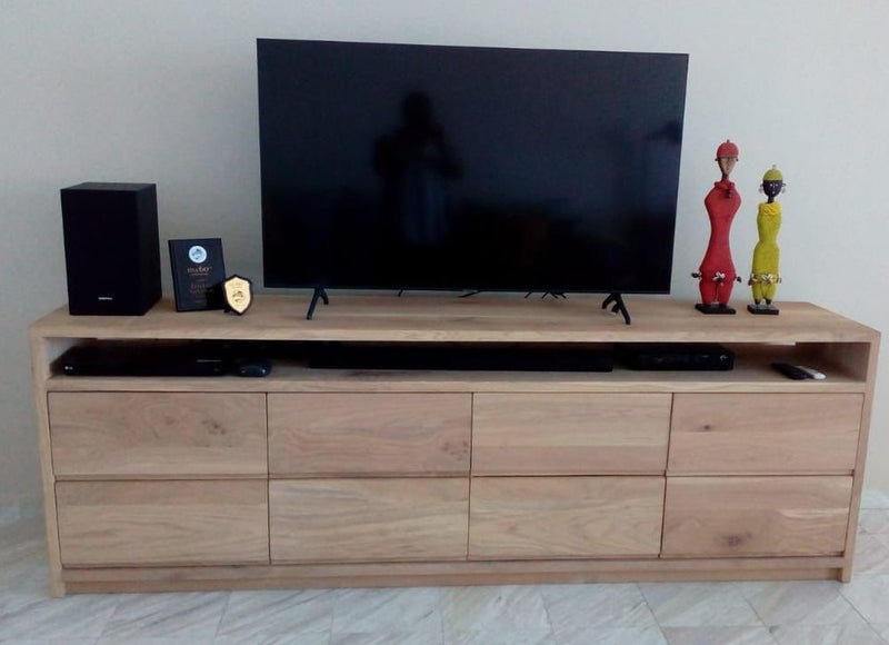 Custom made wooden tv unit with slide out draws and central storage space.