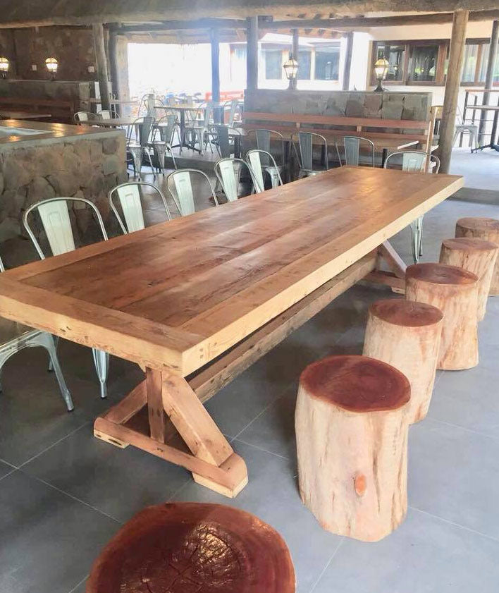 Large custom made wooden dining room table with A legs and long design.