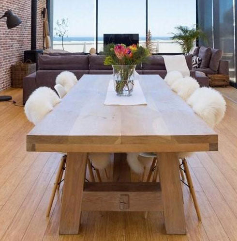 Custom made wooden dining room table with straight legs.