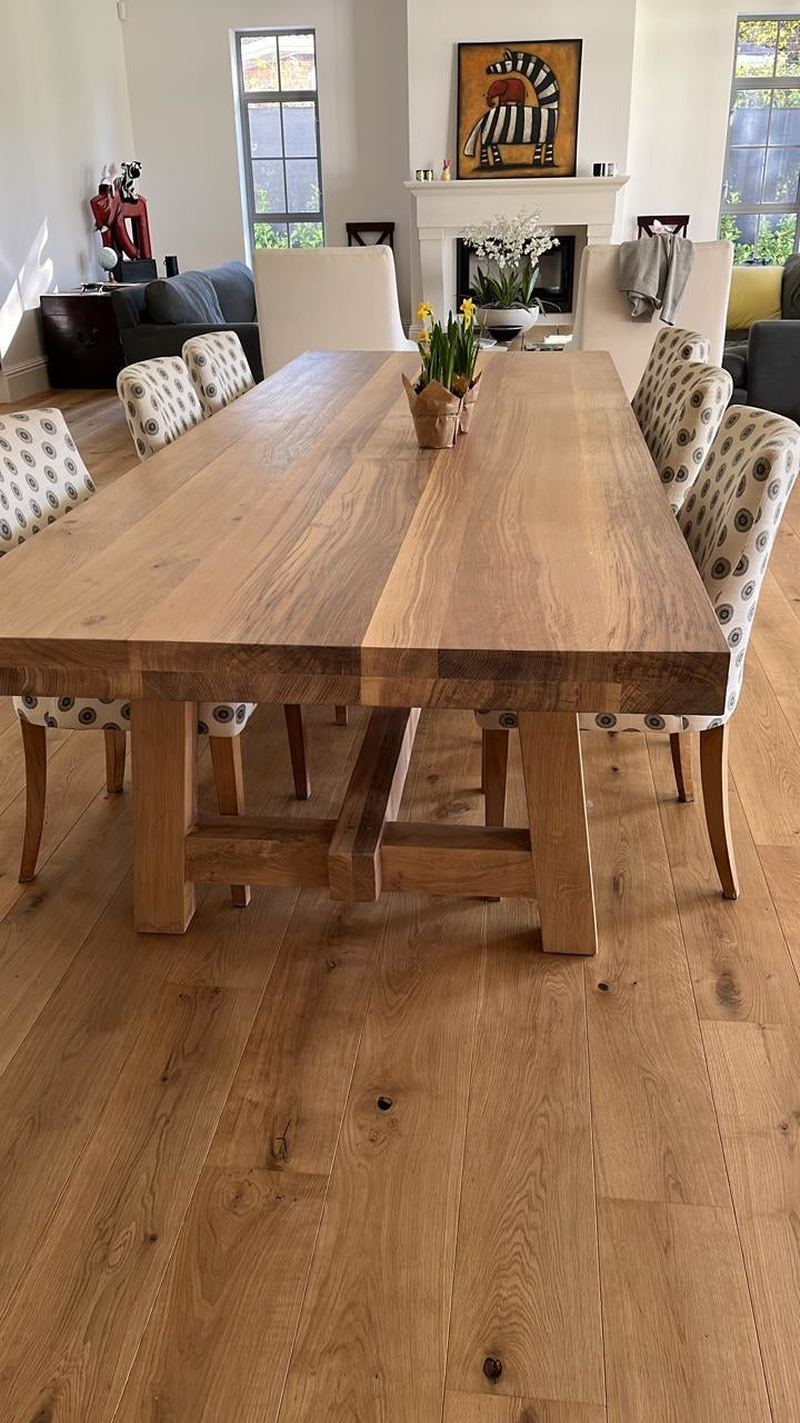 Large custom made wooden dining room table with A legs and centre foot rest. 