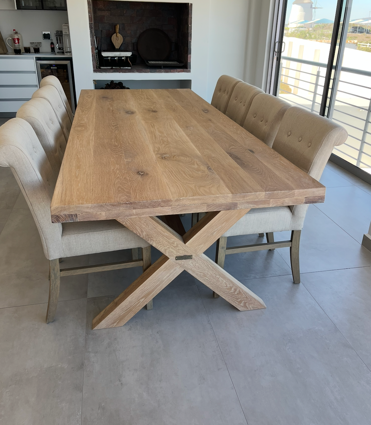Wooden dining table with chairs in a modern kitchen setting for Vintage-etc custom furniture manufacturer
