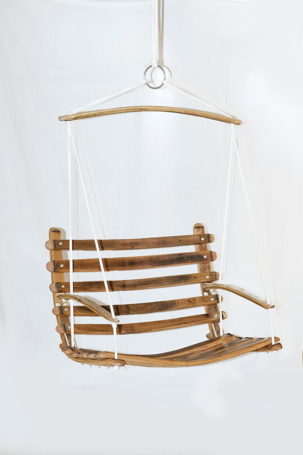 The Aruba Outdoor Swing Chair is handcrafted from 100% recycled Oak wine barrel wood and marine rope. Seats two children. Built to last outdoors.