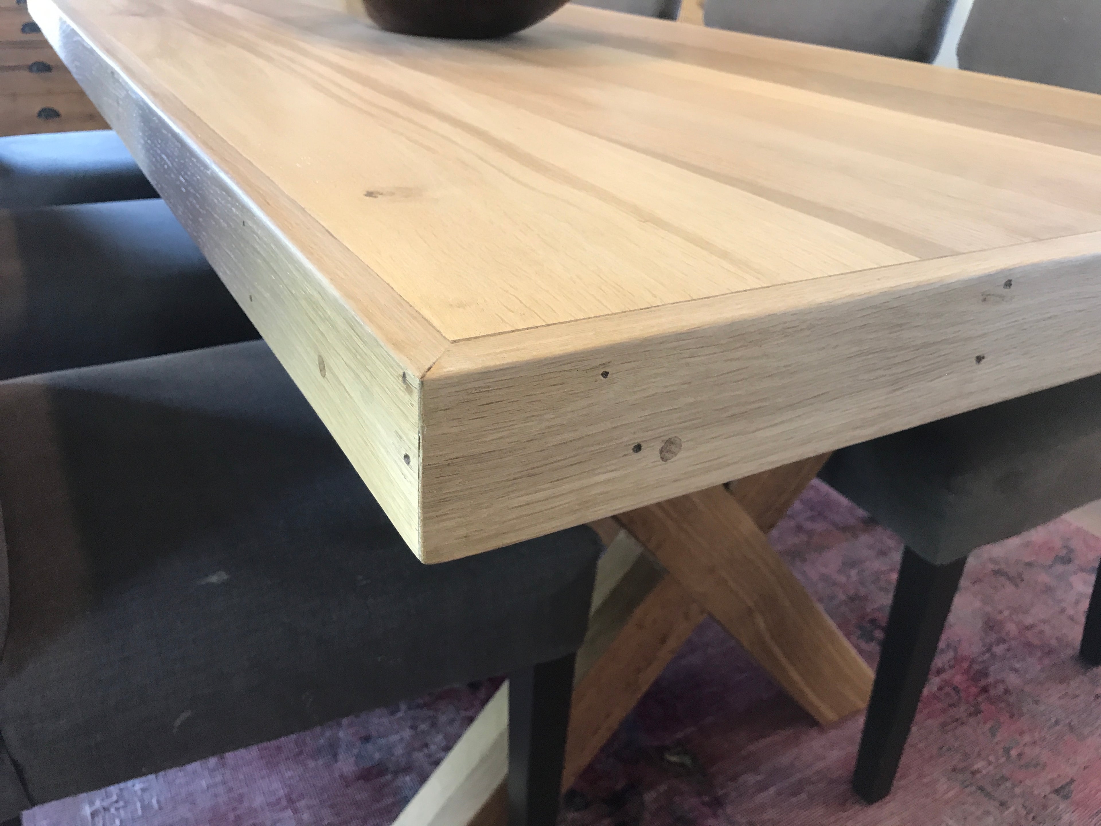 The Framed Border Cross Leg Table has a solid timber top with a framed perimeter border and a sturdy cross-leg base. Custom made to order in SA.