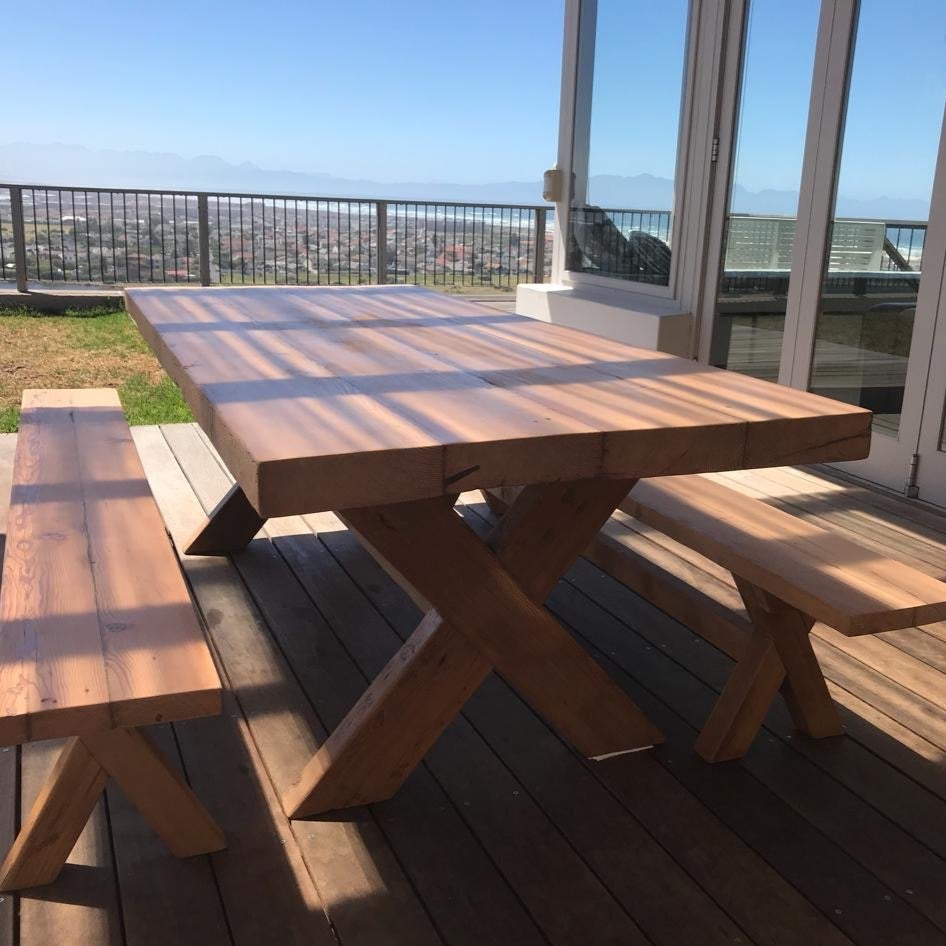 The Frank Cross Leg Table features a solid timber top and a classic cross-leg base. Optional matching benches available. Custom made to order in SA.