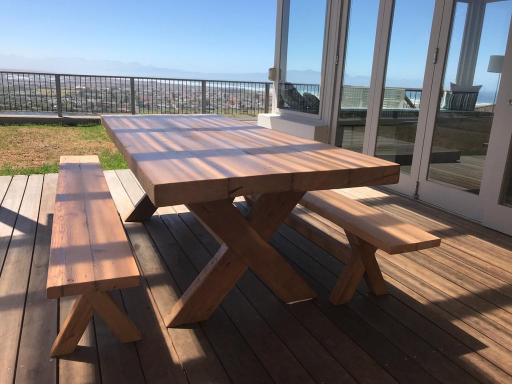 The Frank Cross Leg Table features a solid timber top and a classic cross-leg base. Optional matching benches available. Custom made to order in SA.