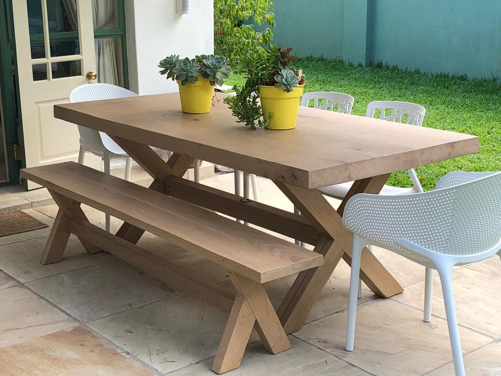 The Frank Cross Leg Table features a solid timber top and a classic cross-leg base. Optional matching benches available. Custom made to order in SA.