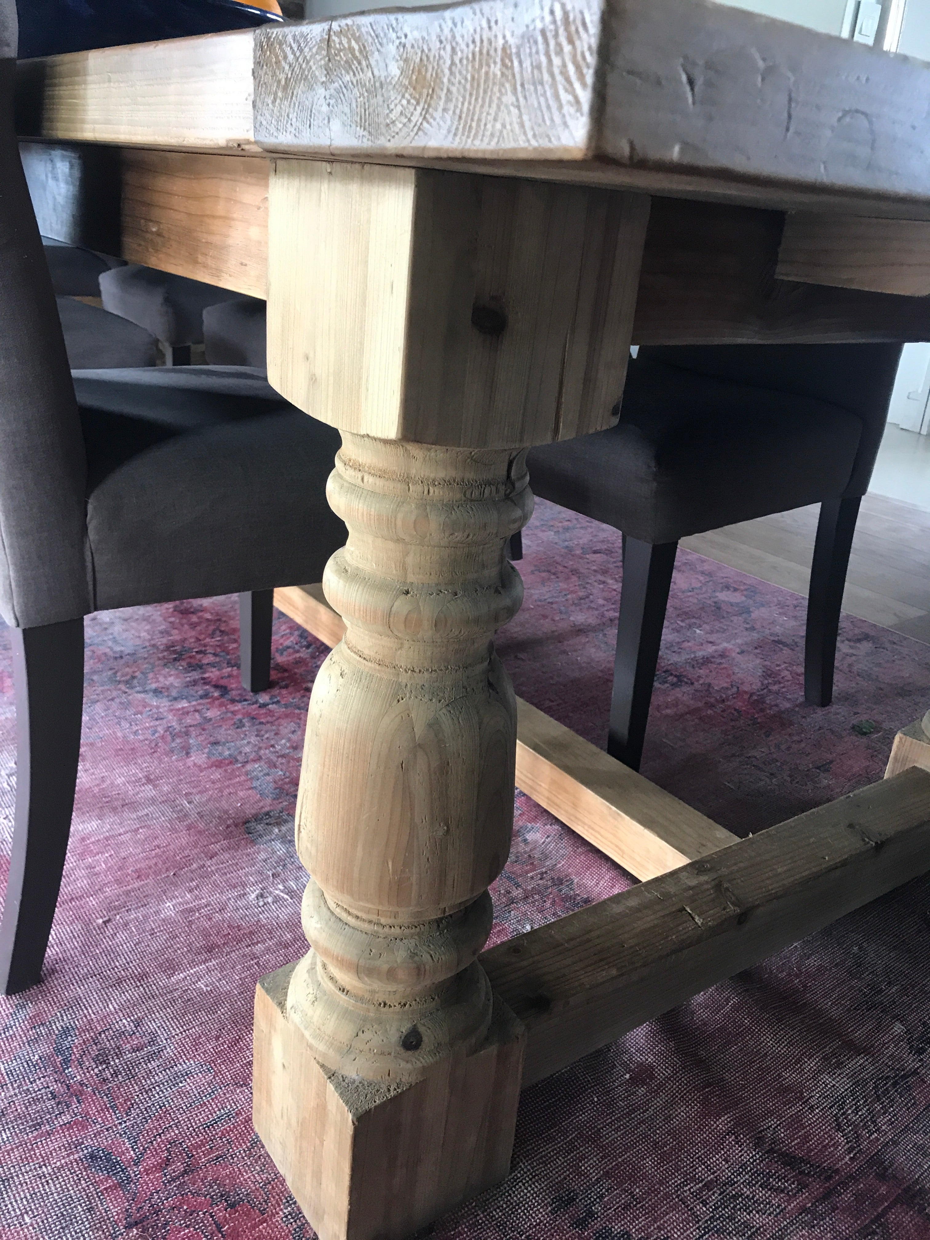 The Rivermist Dining Table features baluster-style turned legs and a reclaimed timber top with natural grain variation. Optional matching benches.