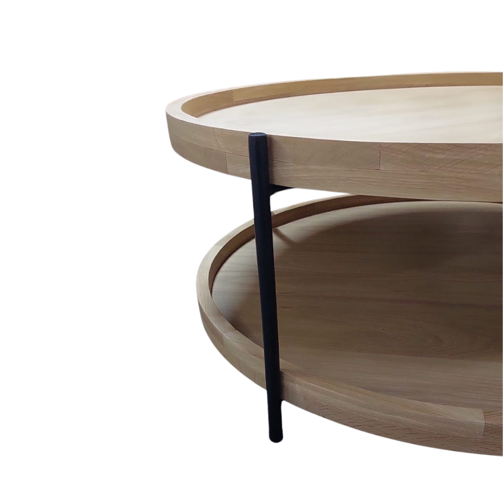 Double tiered round oak coffee table with black tubular frame and legs.