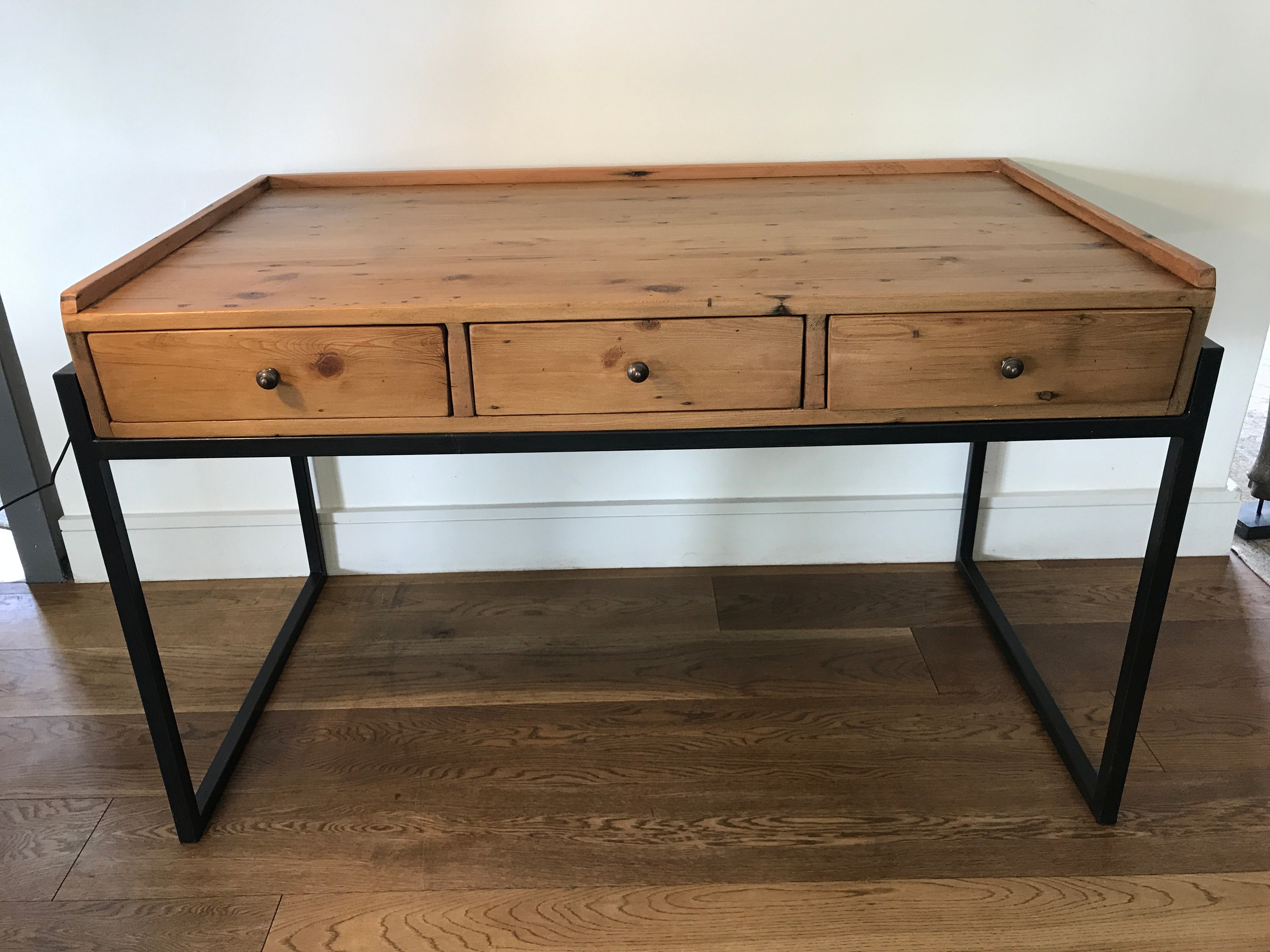 Custom made rustic pine desk with metal legs and three wooden draws.